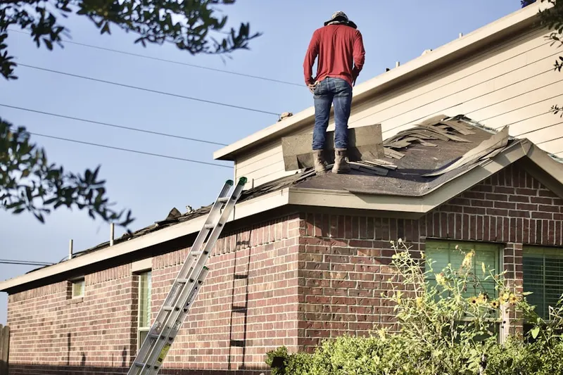 Professional roofer working on a residential roof in Corsicana